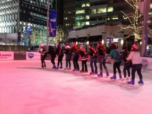 Several language club members do the conga across the icy rink.